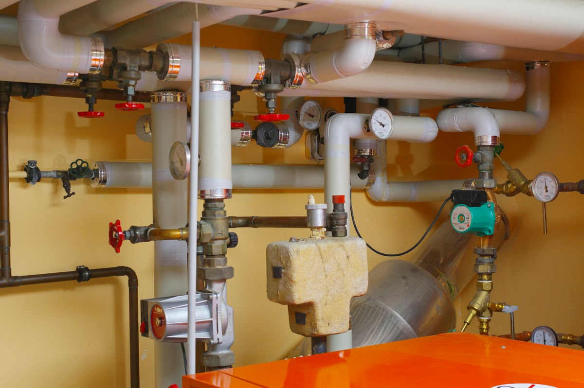 Illustration of a burst pipe spraying water beside a shut-off valve